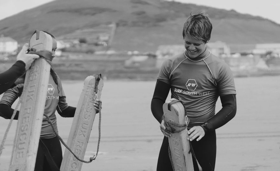 people at beach with surf board