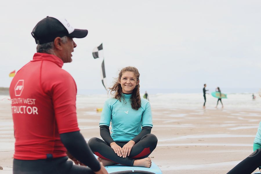 teacher teaching surfing