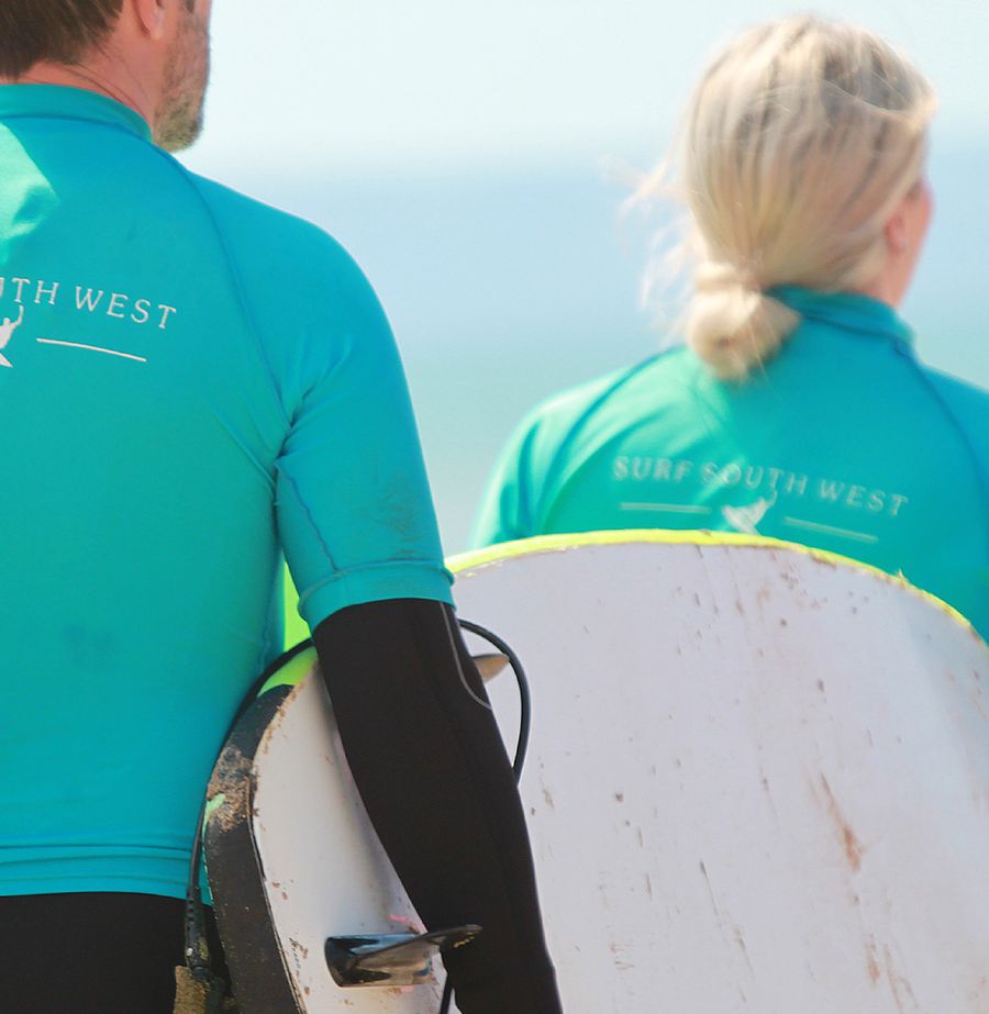 people surfing in the sea with surf lessons
